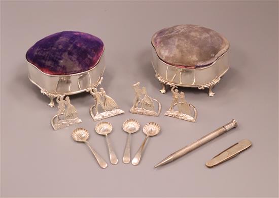 Two silver mounted pin cushions, a set of four George V silver menu holders, four salt spoons, penknife and pen.